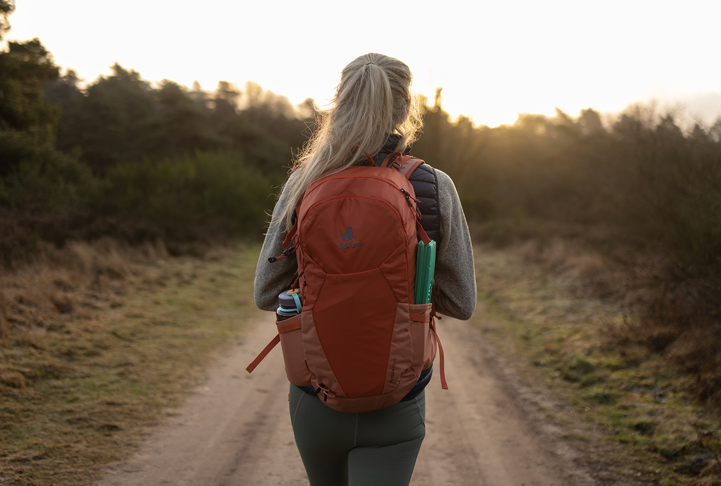 A woman on a walk wearing a daypack 