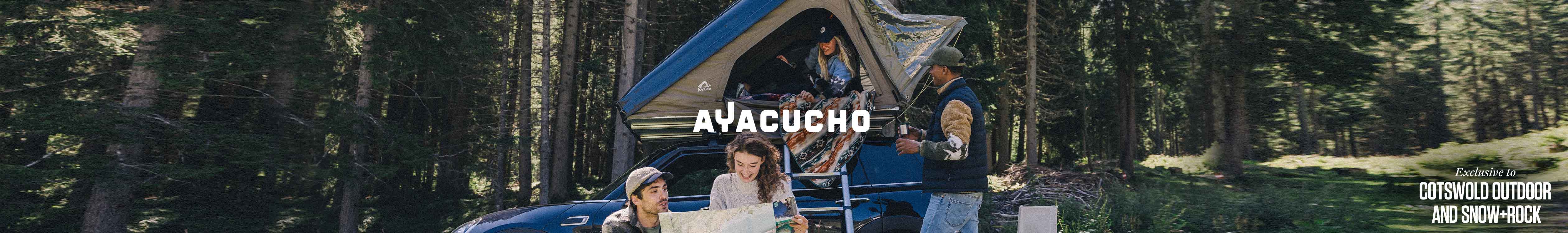 A group of people around a campervan wearing Ayacucho clothing