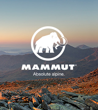 People running through a cave wearing mammut