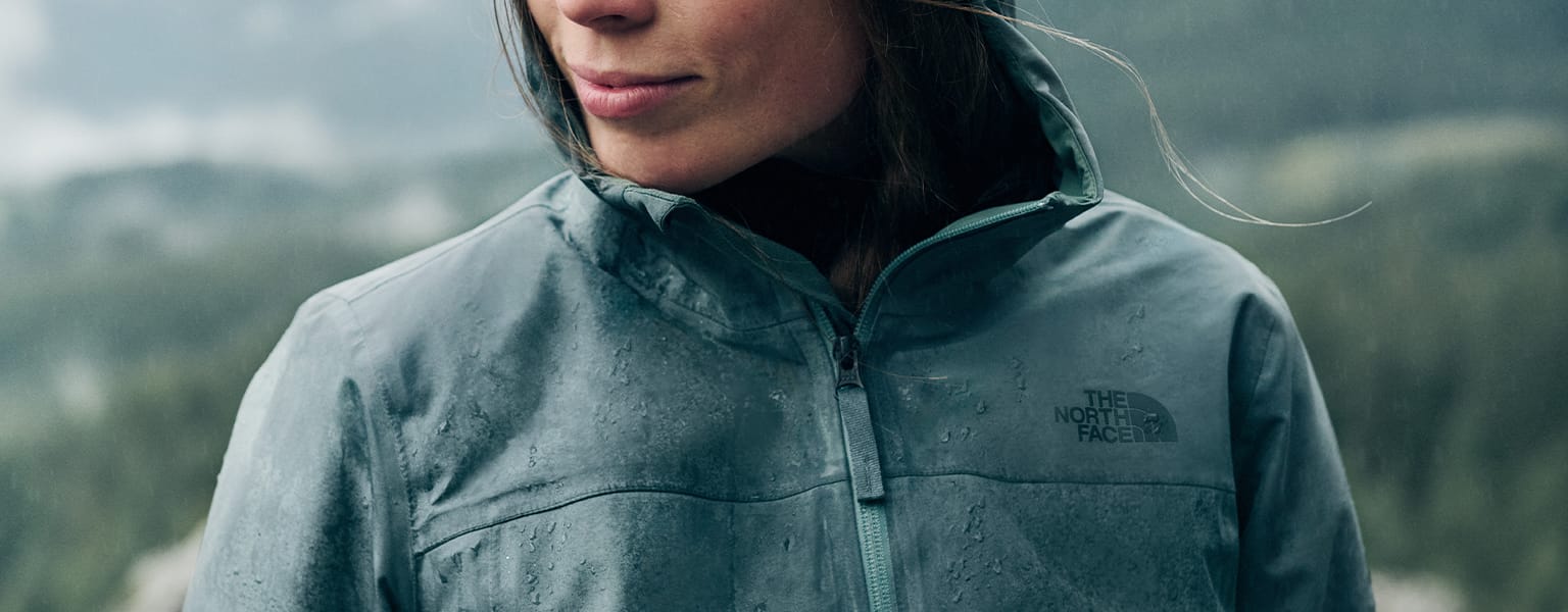 A woman wearing a North Face waterproof jacket in the rain 