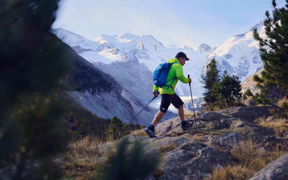 A person hiking with trekking poles in TNF clothing