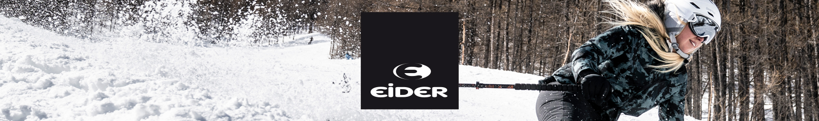 A woman, wearing Eider gear, is skiing down a slope.