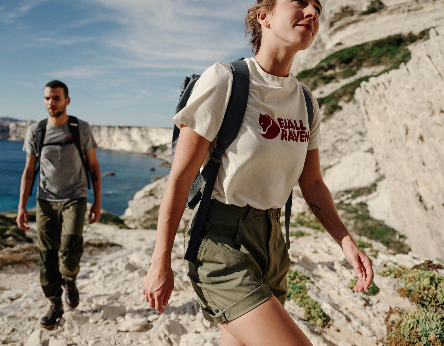 man and woman walking wearing fjallraven 