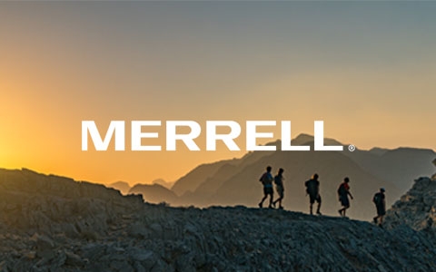 Five people walking in Merrell footwear in the mountains.