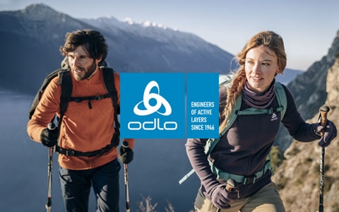 Man and a woman are in the mountains, wearing Odlo gear.