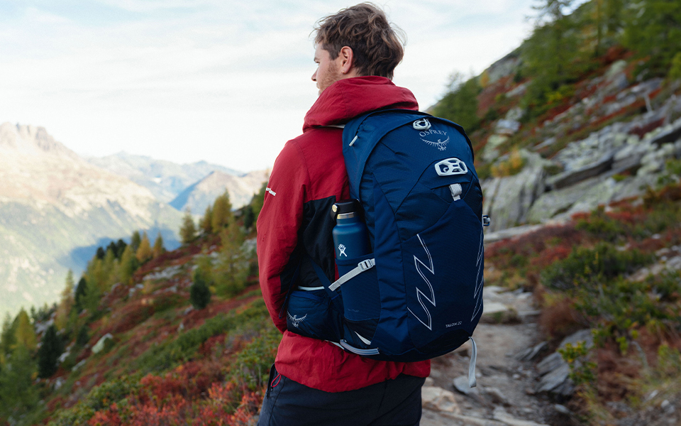 Two people walking along mountain trail