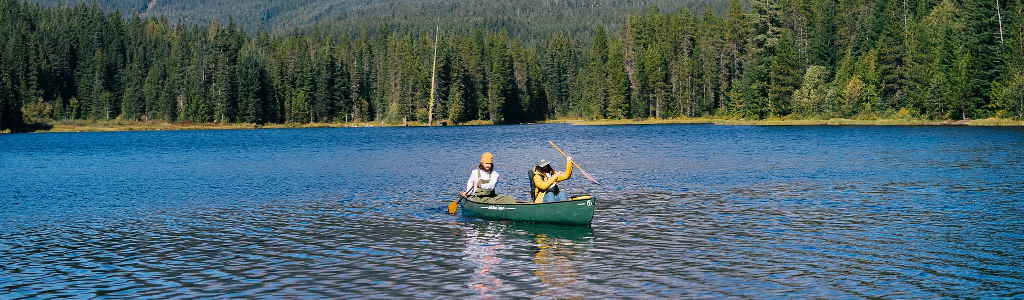 People canoeing in Passenger clothing on a lake 