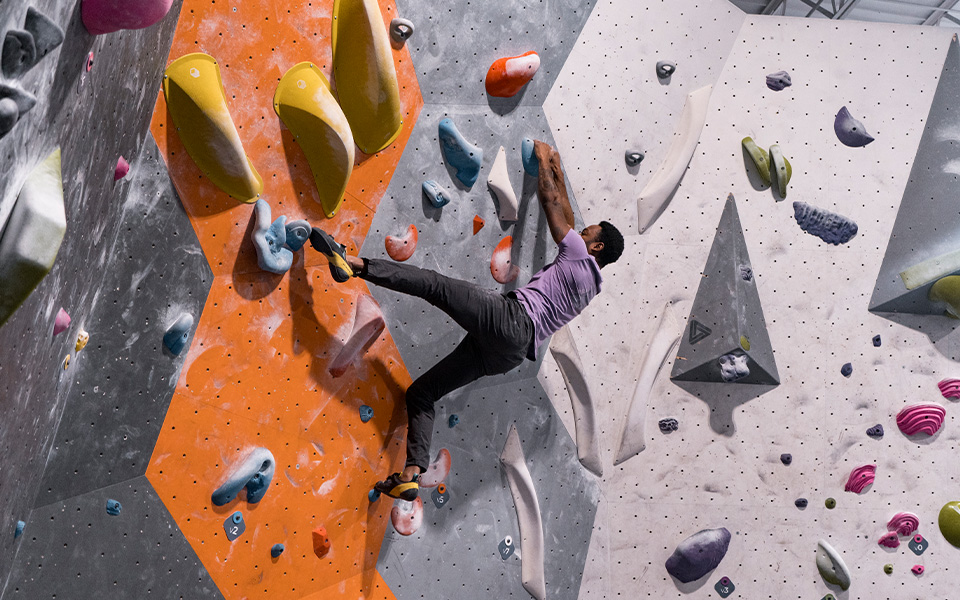 A person climbing in Scarpa climbing shoes