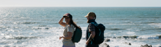 An image of people standing on a hill top