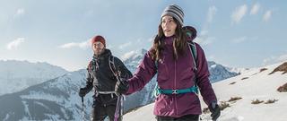 Two people walking through snow