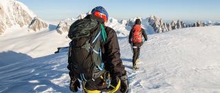 Two people walking through snow