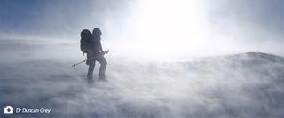Person walking through a snow storm