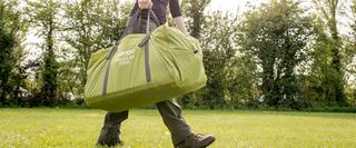 Person carrying vango tent packed up
