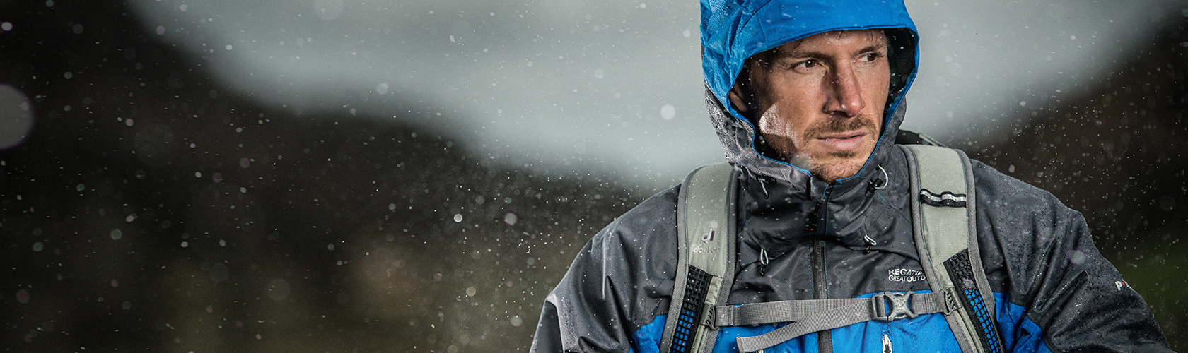 An image of a man wearing a waterproof jacket in the rain 