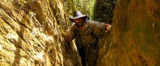 Man Climbing through rocks