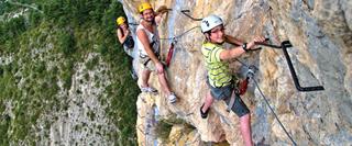 Family of three climbing Via Ferrata