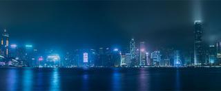 City by the water lit by night lights