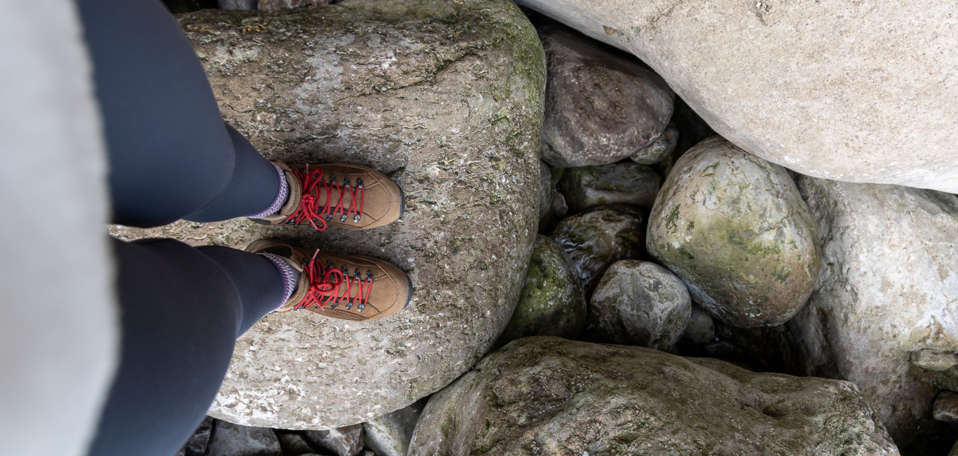 Someone standing on a rock wearing Meindle Balitimore boots