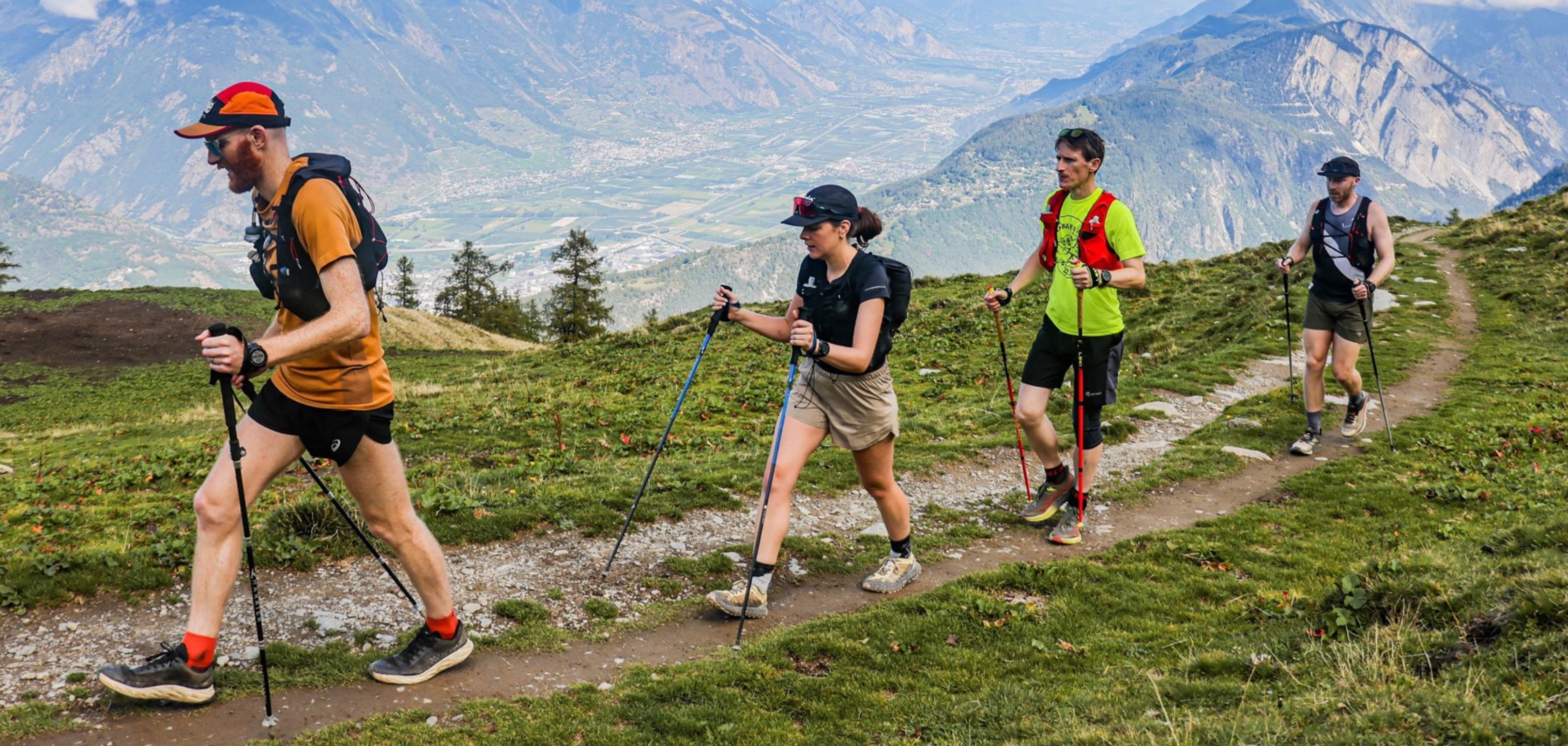 People walking in the mountains with walking sticks