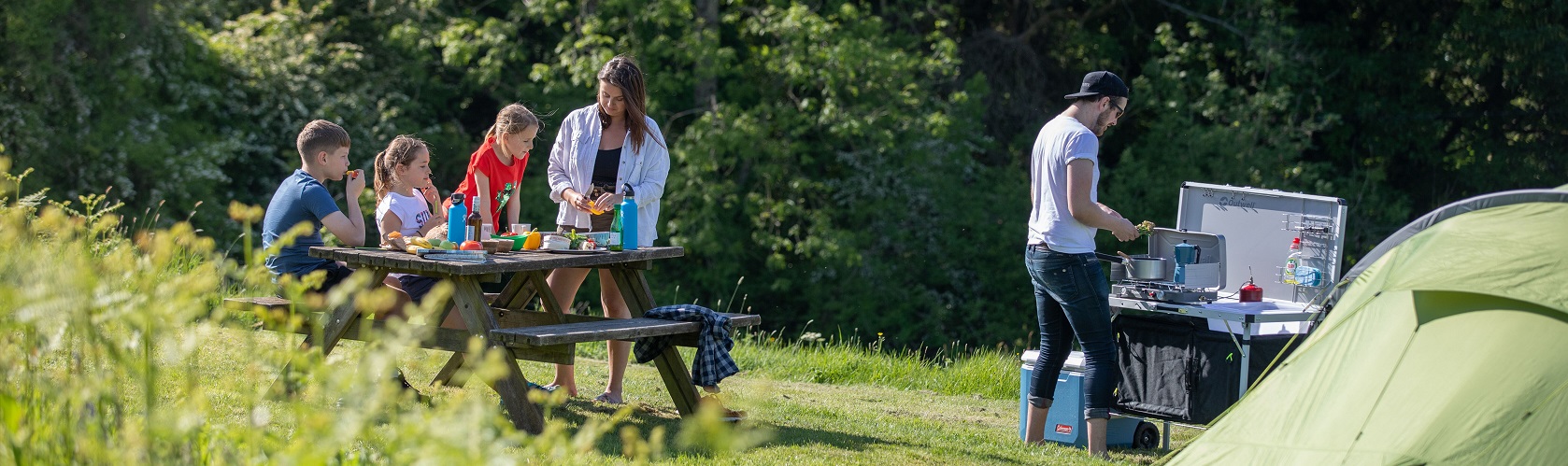 A family cooking at their campsite