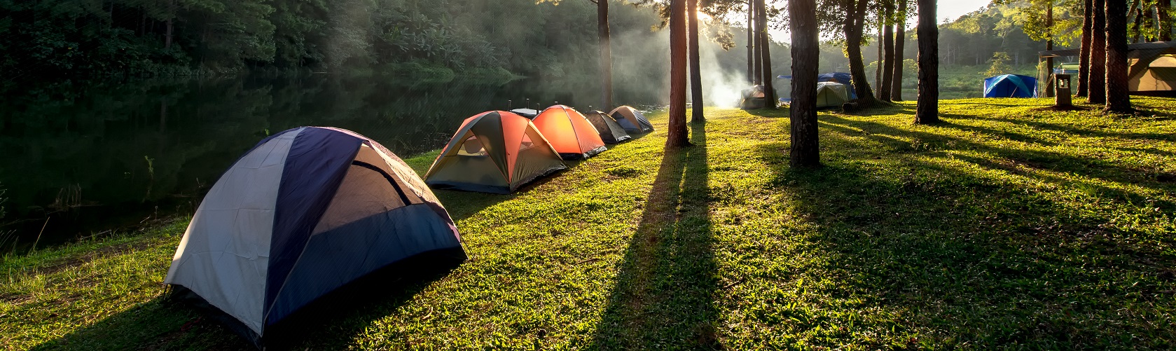 Adventures Camping and tent under the pine forest near water outdoor in morning and sunset at Pang-ung, pine forest park , Mae Hong Son, North of Thailand, forest background. Concept Travel