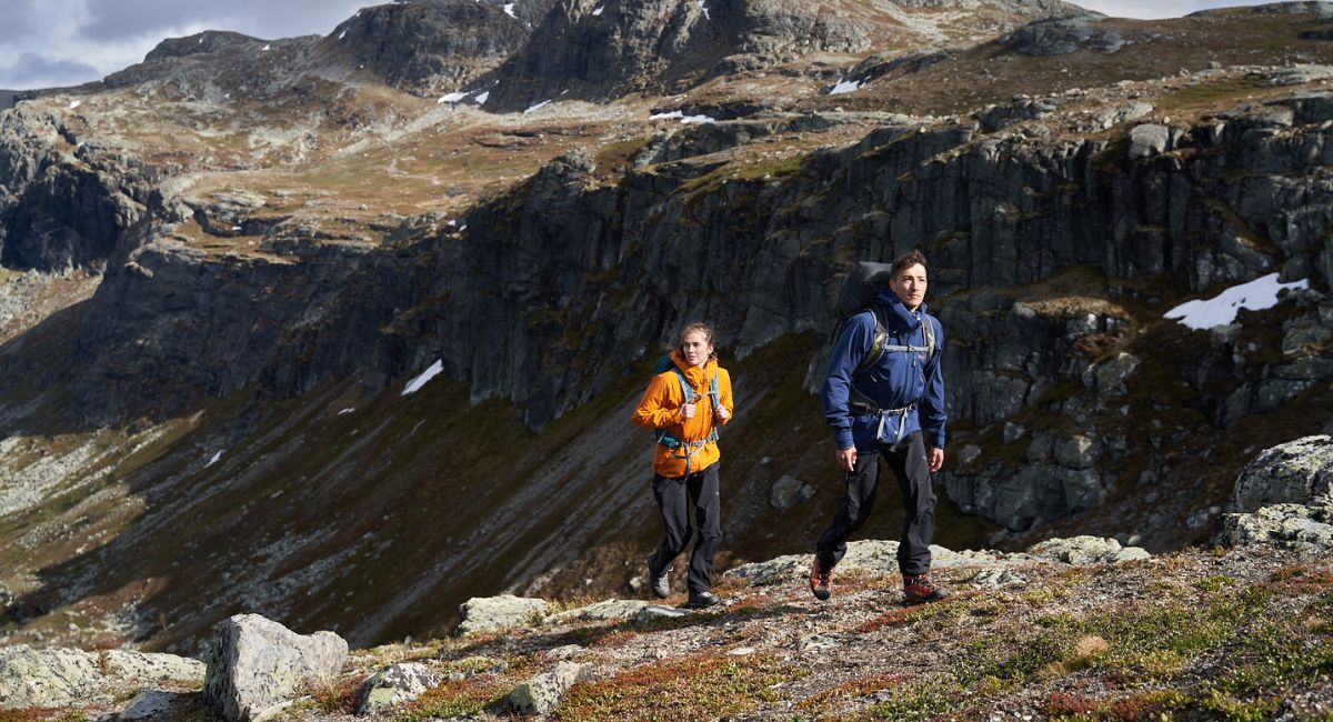 Two people hiking in Rab waterproof clothing 