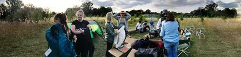 Teenagers are outdoors with boxes of stuff from Outdoor and Cycle Concepts