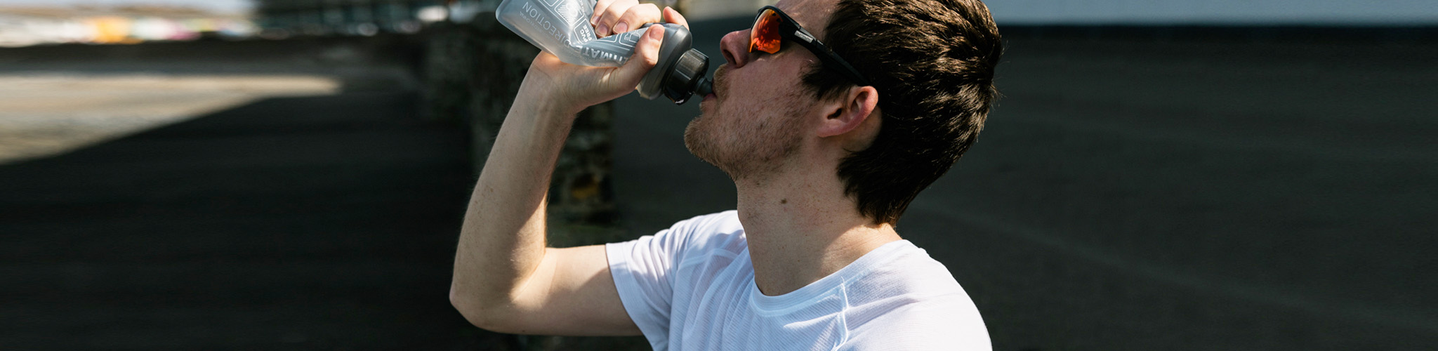 Man drinking water outdoors