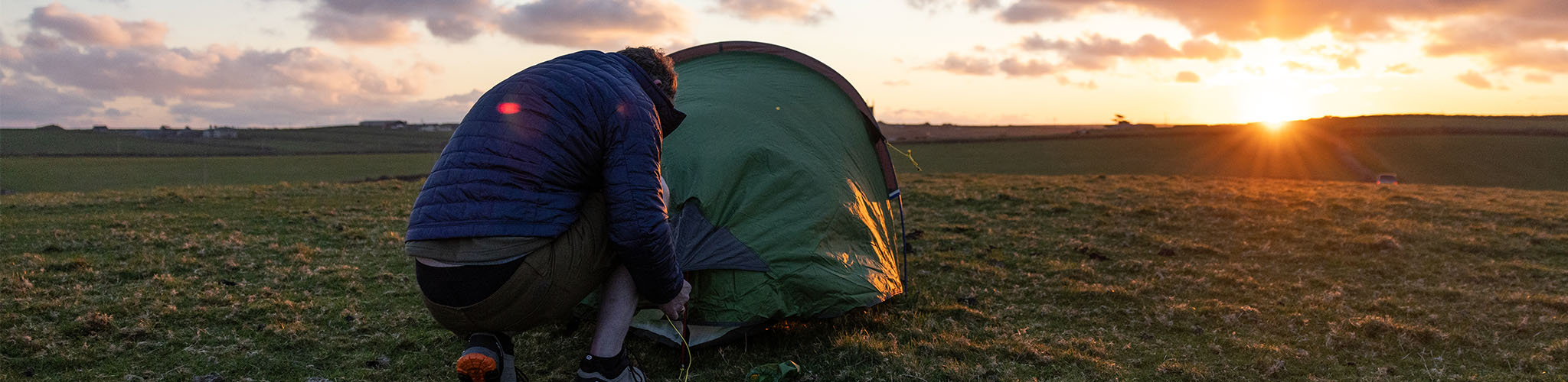Person pitching up a tent