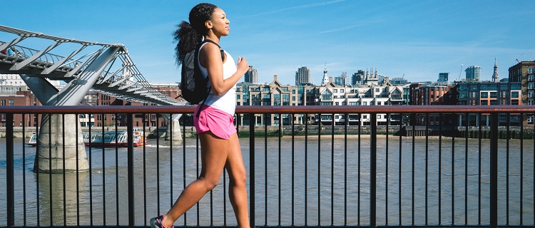 Beautiful woman running in city street.