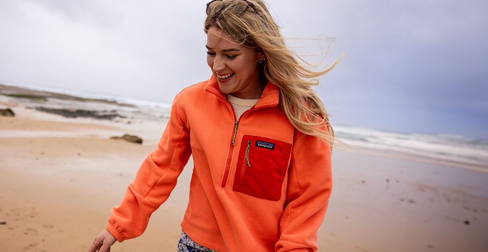 Woman wearing a fleece on the beach