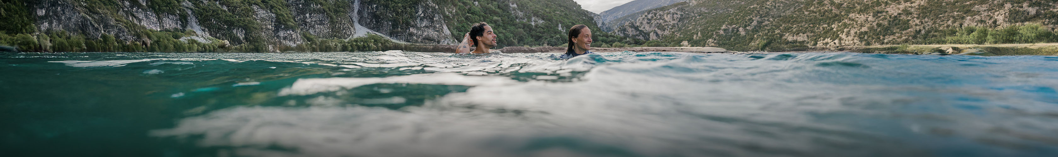 An image of two people wild swimming 