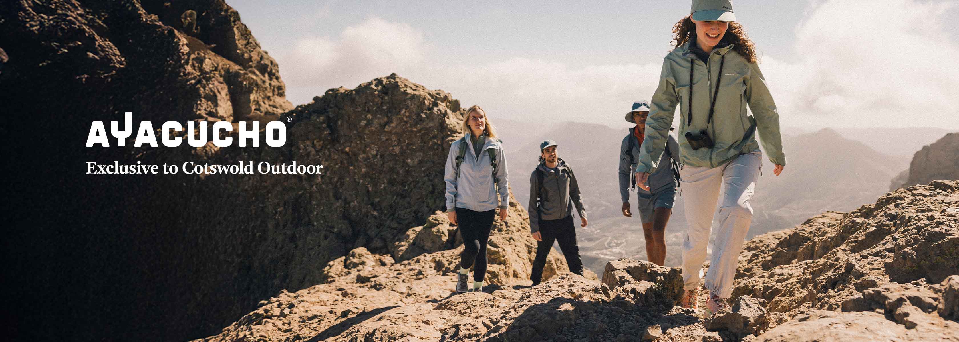 Shop Ayacucho collection. Two people in playful motion in a woodland setting