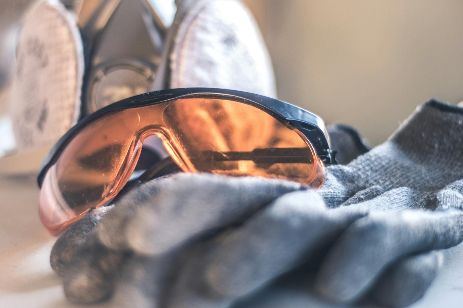 An image of protective goggles on work gloves